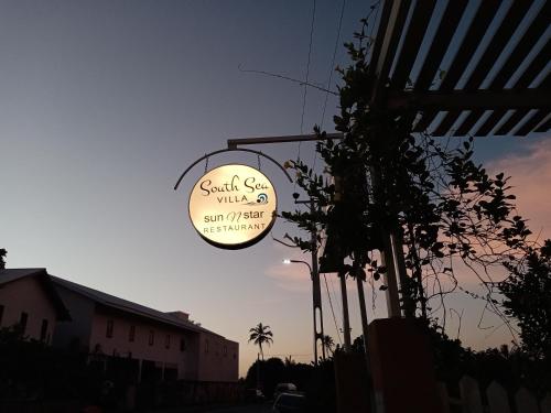 a sign for a sushi shop on a street at South Sea Villa in Midigama