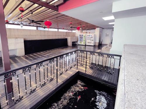 a koi pond in the middle of a building at The Snooze Hotel Marine Parade in Singapore