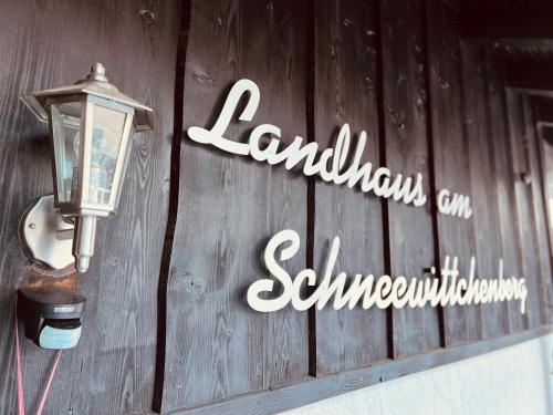 a sign on the side of a building with a street light at Landhaus am Schneewittchenberg in Sonthofen