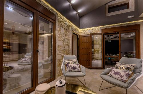 a living room with two chairs and a table at TheLuxuryVillas in Preveza