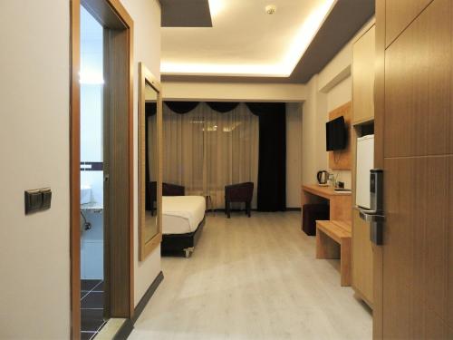 a hotel room with a bed and a desk at INN TOWN HOTEL in Eskisehir
