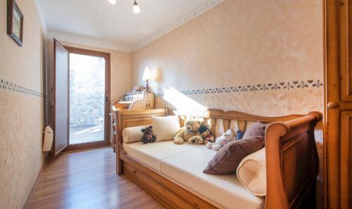 a bedroom with a bed with stuffed animals on it at Casa La morera del Montsant in La Morera de Montsant
