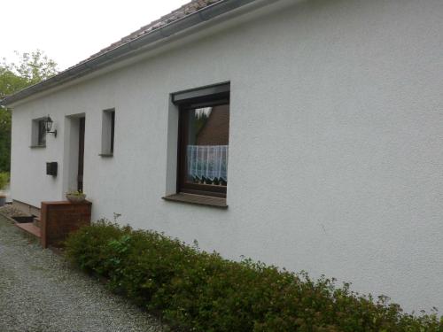 a white house with a window on the side of it at FeWo Ostseestrand in Neustadt in Holstein