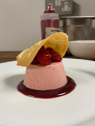 a pink dessert with fruit on a white plate at Lagom Restaurant & Townhouse in Kenmare