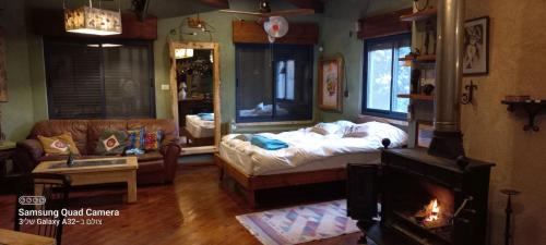 a living room with a bed and a couch at קטלב kta-love in Kammon
