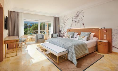 a bedroom with a bed and a living room at Grupotel Parc Natural & Spa in Playa de Muro