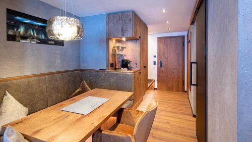 a dining room with a wooden table and chairs at Belavita B&B in Ischgl