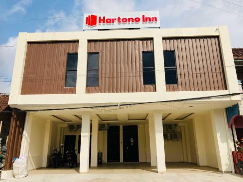 a building with a harma inn sign on top at Hartono Inn Seturan Mitra RedDoorz in Seturan