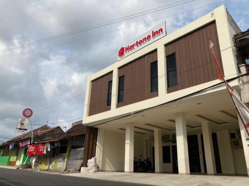 a building with a sign on top of it at Hartono Inn Seturan Mitra RedDoorz in Seturan