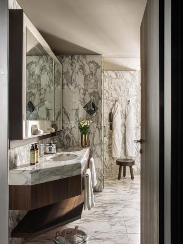 a bathroom with a sink and a shower at ME Milan Il Duca in Milan