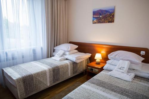 a hotel room with two beds and a window at DW Halicz in Solina