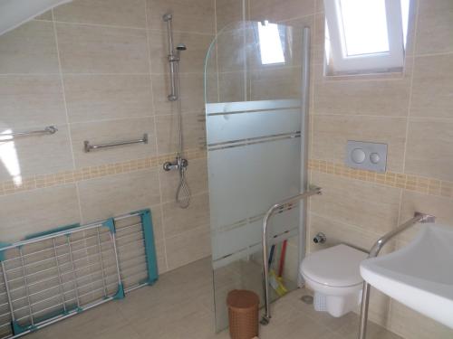 a bathroom with a shower and a toilet and a sink at VillaSevval - Stunning 4-Bed Villa in Dalyan