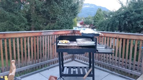 a barbecue grill on a deck with a fence at Familien Zeit in Bad Mitterndorf