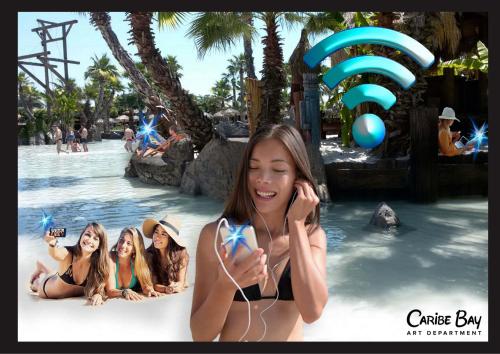 a girl talking on a cell phone at a theme park at Domino Suite Hotel & Residence in Lido di Jesolo
