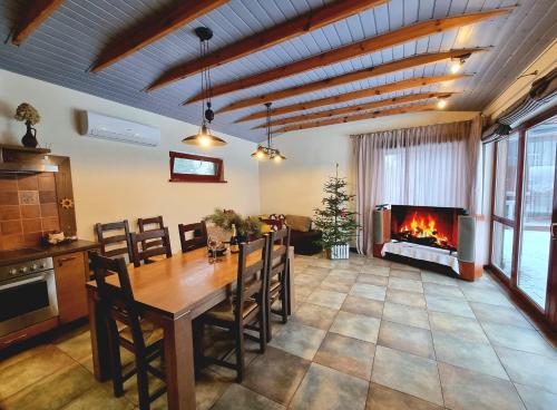 a living room with a table and a fireplace at Jaunstūrīši in Ādaži