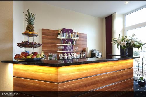 a bar in a hotel with fruit on the counter at Hotel Panorama in Heidelberg