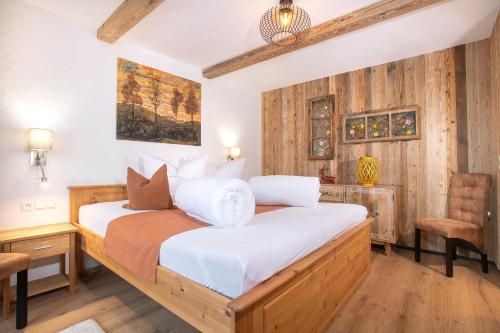 a bedroom with a bed and a desk and a chair at Gasthof Dorfwirt Sandgruber Ges.m.b.H in Pertisau