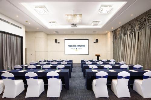 a conference room with blue tables and white chairs at Shenzhen Bay Hisoar Hotel in Shenzhen