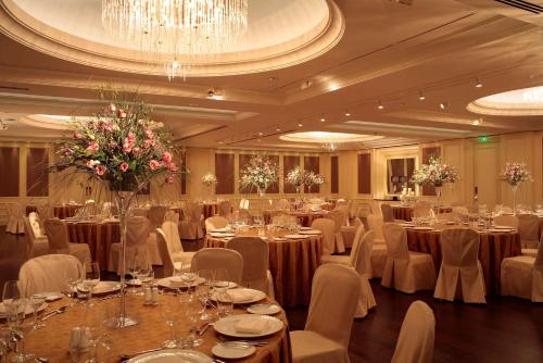 a banquet hall with tables and chairs and a chandelier at Hyatt Regency Kyiv in Kyiv