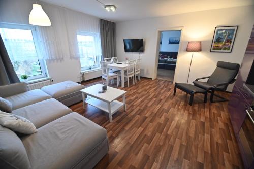a living room with a couch and a table and chairs at Pension am Schloss in Schwerin