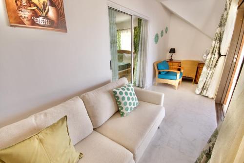 a living room with a couch and a chair at SEA SPLASH SELF CATERING And La Petite Maison in Grand Anse