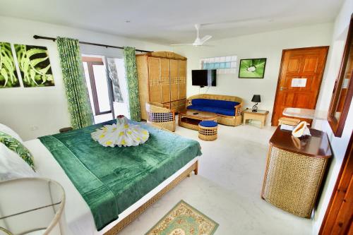 a living room with a bed and a couch at SEA SPLASH SELF CATERING And La Petite Maison in Grand Anse