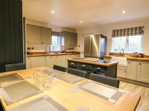 a kitchen with a wooden table with chairs and a dining room at Island View House in Ballachulish
