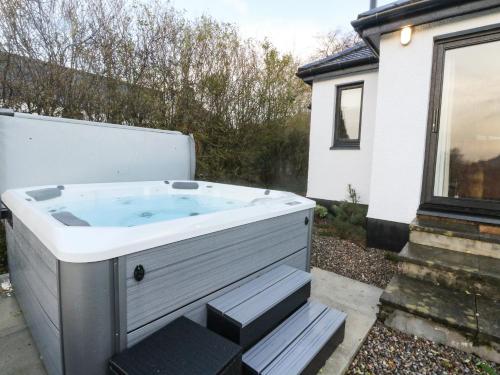 a hot tub in the backyard of a house at Island View House in Ballachulish