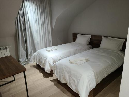 מיטה או מיטות בחדר ב-Genesis Bakuriani