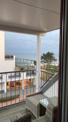 a balcony with a table and a view of the ocean at Inspiration Maisonette in Scharbeutz