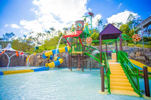 a water park with a water slide in the water at Fazzenda Park Resort in Gaspar
