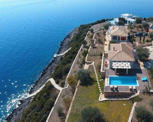 an aerial view of a house and the ocean at Iris Villas Lefkada - Marine Villa with private sea access in Sivota