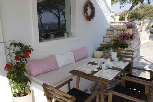 a living room with a couch and a table at Almira Suites - Seafront - Naousa Paros in Naousa