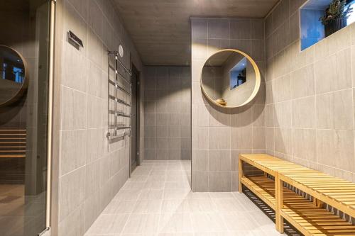 a bathroom with a bench and a mirror at Sälen Mountain Lodge in Sälen