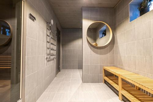 a bathroom with a bench and a mirror at Sälen Mountain Lodge in Sälen