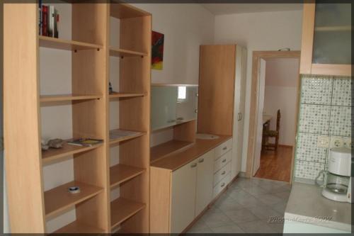 a kitchen with wooden shelves in a room at Apartment in Bol with sea view, terrace, air conditioning, WiFi 3739-1 in Bol