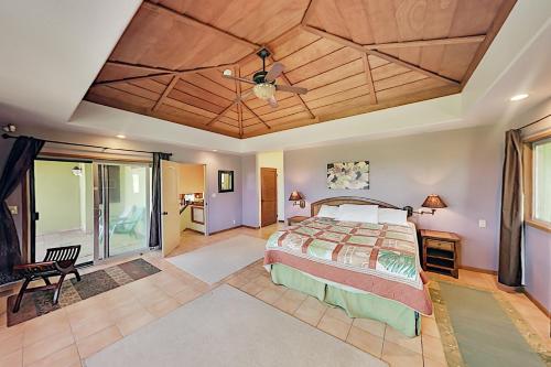 a bedroom with a bed and a ceiling fan at Mele Kai in Keaau