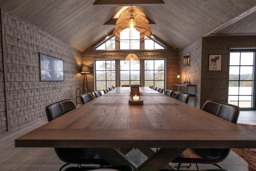 a large conference room with a large wooden table and chairs at Sälen Mountain Lodge in Sälen