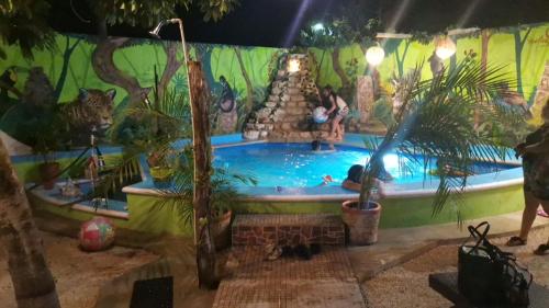 a pool in a room with people in the water at Zayali Bacalar - Guest House in Bacalar