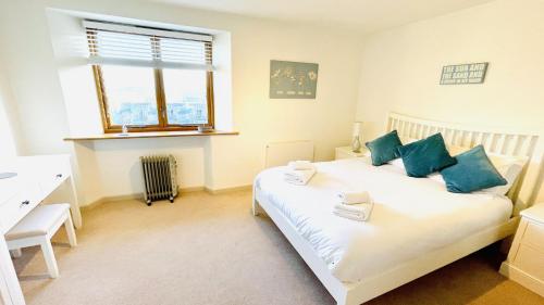 a bedroom with a bed and a desk and a window at Keepers Cottage - Dartmouth Golf and Spa Resort in Dartmouth