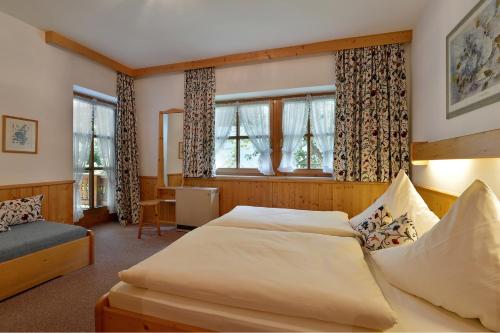 a bedroom with two beds and a window at Haus Gaisberger in Mayrhofen