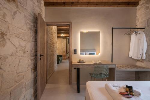 a bathroom with a stone wall and a sink at Villa Magnolia in Ayiá