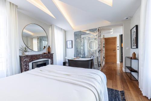 a bedroom with a bed and a mirror and a desk at Le Dortoir Boutique Suites in Nice