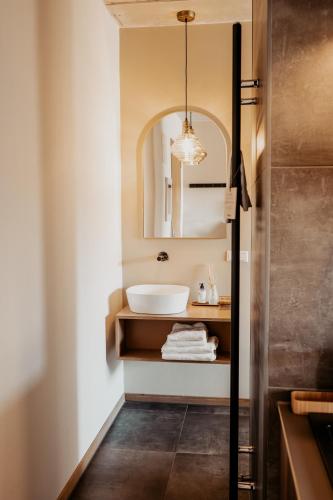a bathroom with a sink and a mirror at Strandhotel Zoomers in Castricum