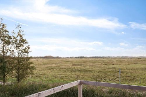 a field with a fence and a field with animals in it at Landgoed Hermitage - Villa Euphoria - XXL Zwemspa - Max 10 personen in Ouddorp