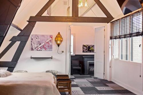 a bedroom with a bed and a fireplace at Landgoed Hermitage - Villa Euphoria - XXL Zwemspa - Max 10 personen in Ouddorp