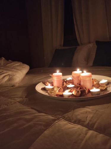 a plate with candles on top of a bed at Villa Anthemida Chania in Ayiá
