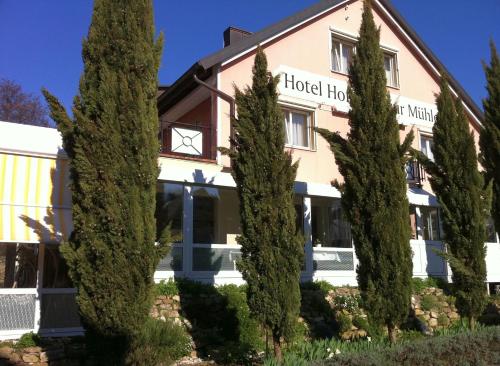 a hotel with trees in front of it at Hotel Hofmann Zur Mühle in Bad Krozingen