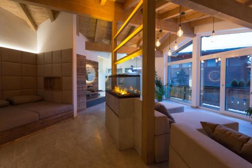 a living room with a fireplace and a couch at Der Zirmhof in Saalbach in Saalbach Hinterglemm