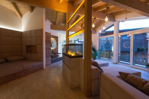 a living room with a fireplace and a couch at Der Zirmhof in Saalbach in Saalbach-Hinterglemm